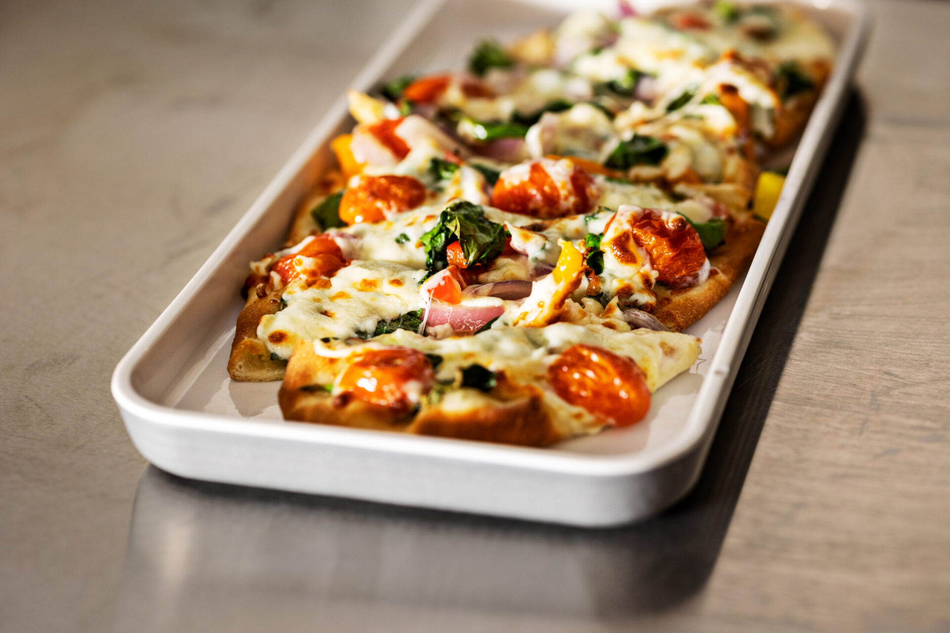 Freshly baked flatbread pizza with mozzarella cheese and bold toppings at 404 Sports Bar & Grill in Morrow, Georgia